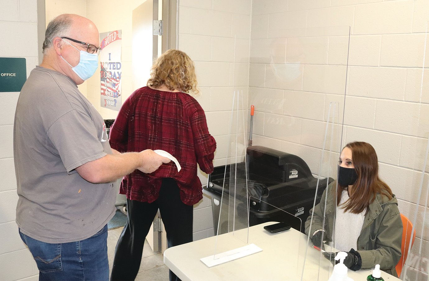 Todd Sheetz, left, prepares to cast his vote Tuesday at North Montgomery High School while poll worker Melissa Dees, seated, instructs him how to use the ballot box.